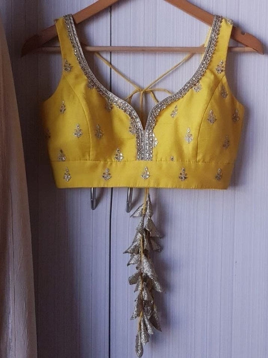 Mustard Yellow Embroidered Sleeveless Blouse with Deep Neck & Tassel Tie-Up Back